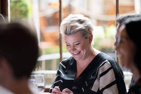 Photograph focused on Tesco head of personal injury and fraud Ami North, laughing at the roundtable. She has short, platinum blonde hair and wears a black and white blouse.